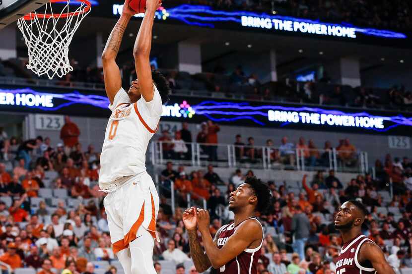 Texas Longhorns forward Gerald Liddell (0) dunks over Texas A&M Aggies guard Quenton Jackson...