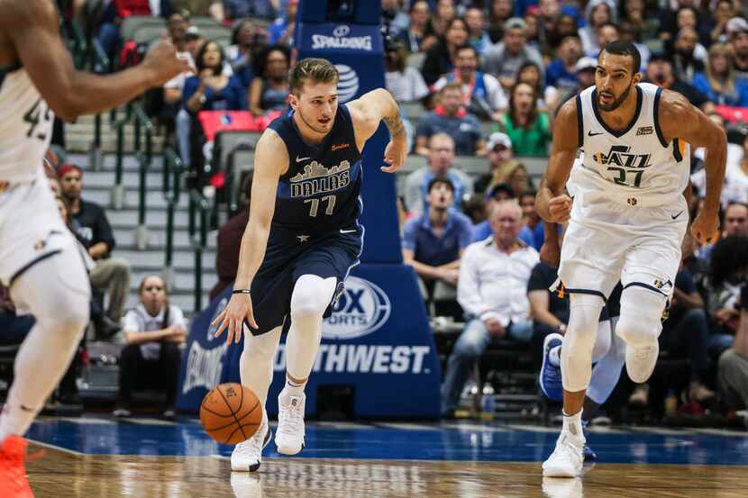 Dallas Mavericks forward Luka Doncic (77) makes a break downcourt past Utah Jazz center Rudy...