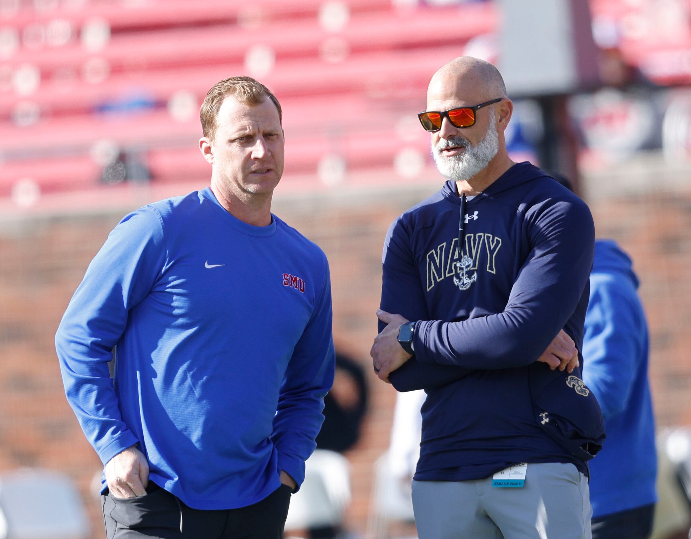 SMU head coach Rhett Lashlee, left, talks with Navy head coach Brian Newberry before an NCAA...