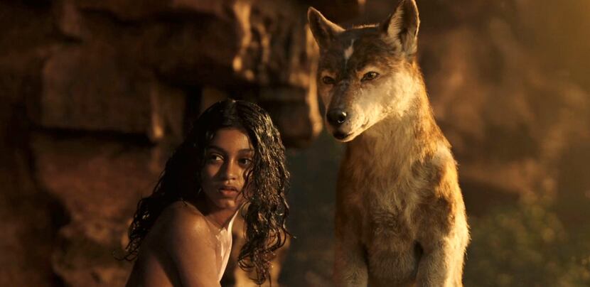 Rohan Chand's Mowgli, left, and Nishi, voiced by Naomie Harris, in a scene from the film,...