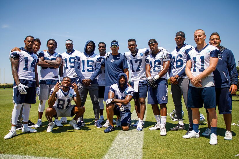 Dallas Cowboys wide receivers pose for a photo around wide receivers coach Sanjay Lal...