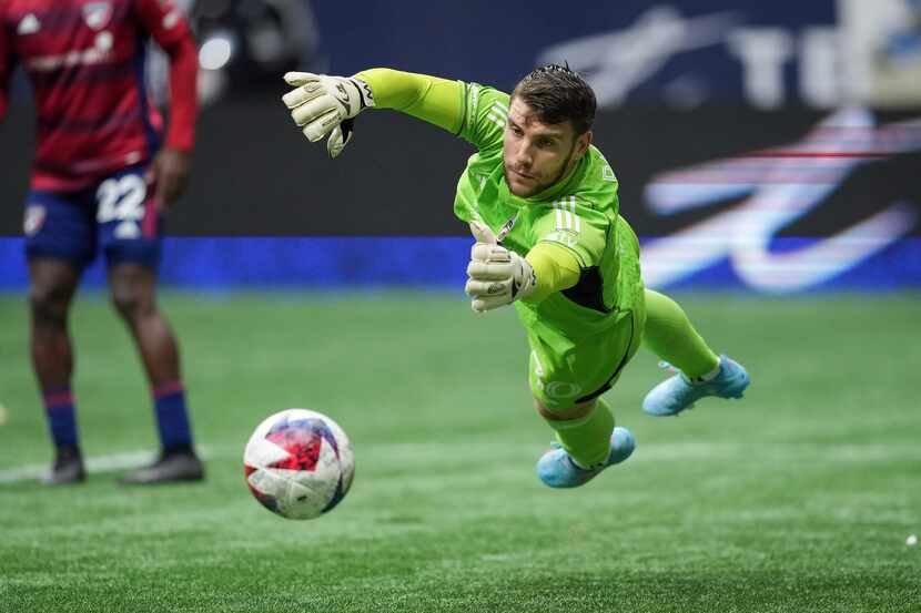 FC Dallas goalkeeper Maarten Paes dives for the ball as it goes wide of the goal during the...
