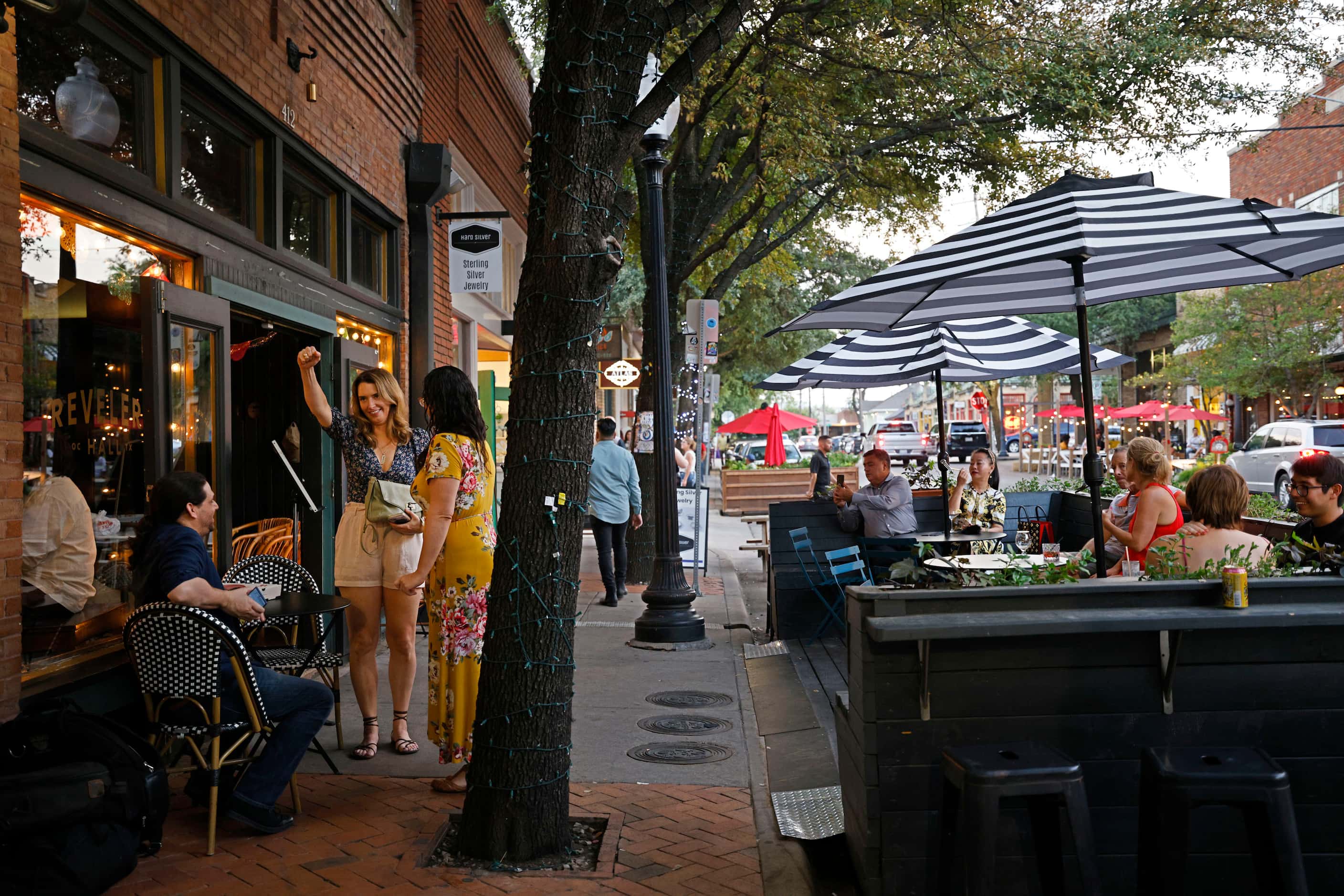 People sit on the patio at Revelers Hall in the Bishop Arts District in Dallas, Saturday,...