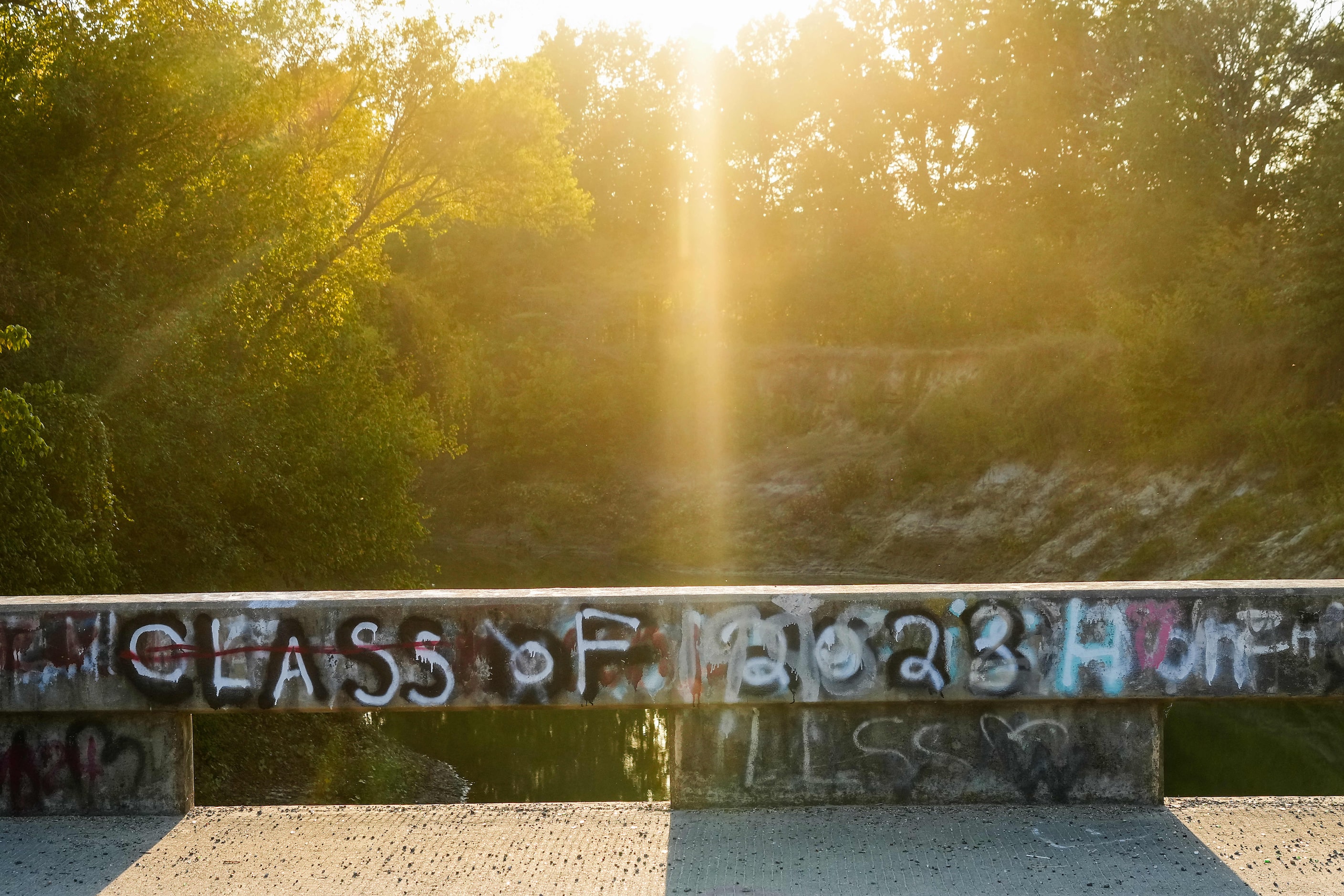 The sun sets on a graffiti covered bridge crossing the Sulphur River on Monday, Oct. 14,...