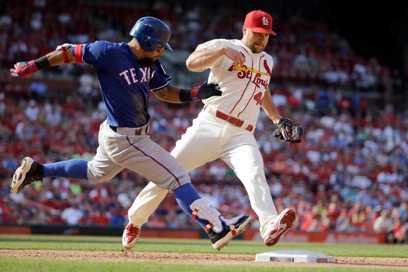 Texas Rangers' Rougned Odor, left, is safe at first for a single as he beats St. Louis...