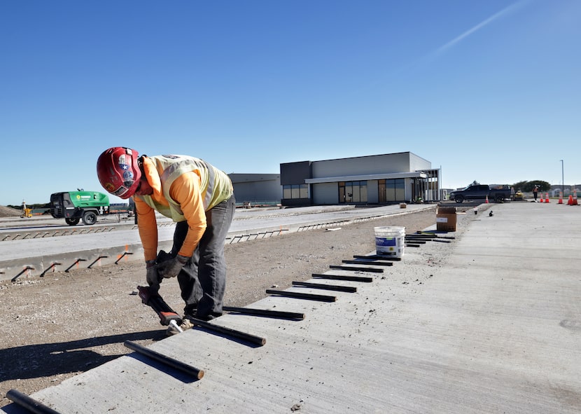 Workers build the U.S. customs center at the McKinney National Airport in McKinney, TX, on...