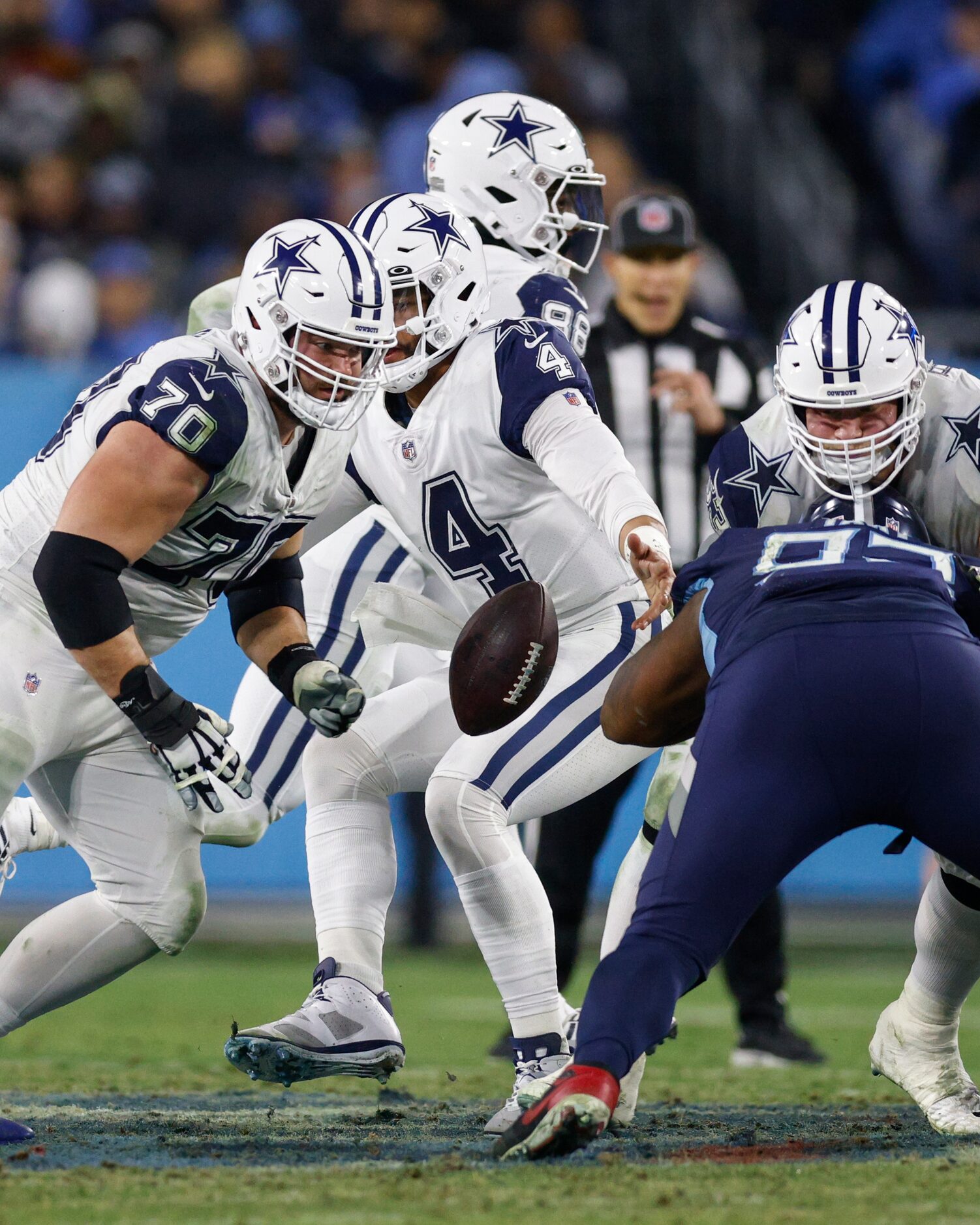 Dallas Cowboys quarterback Dak Prescott (4) fumbles the snap from center Tyler Biadasz (63)...