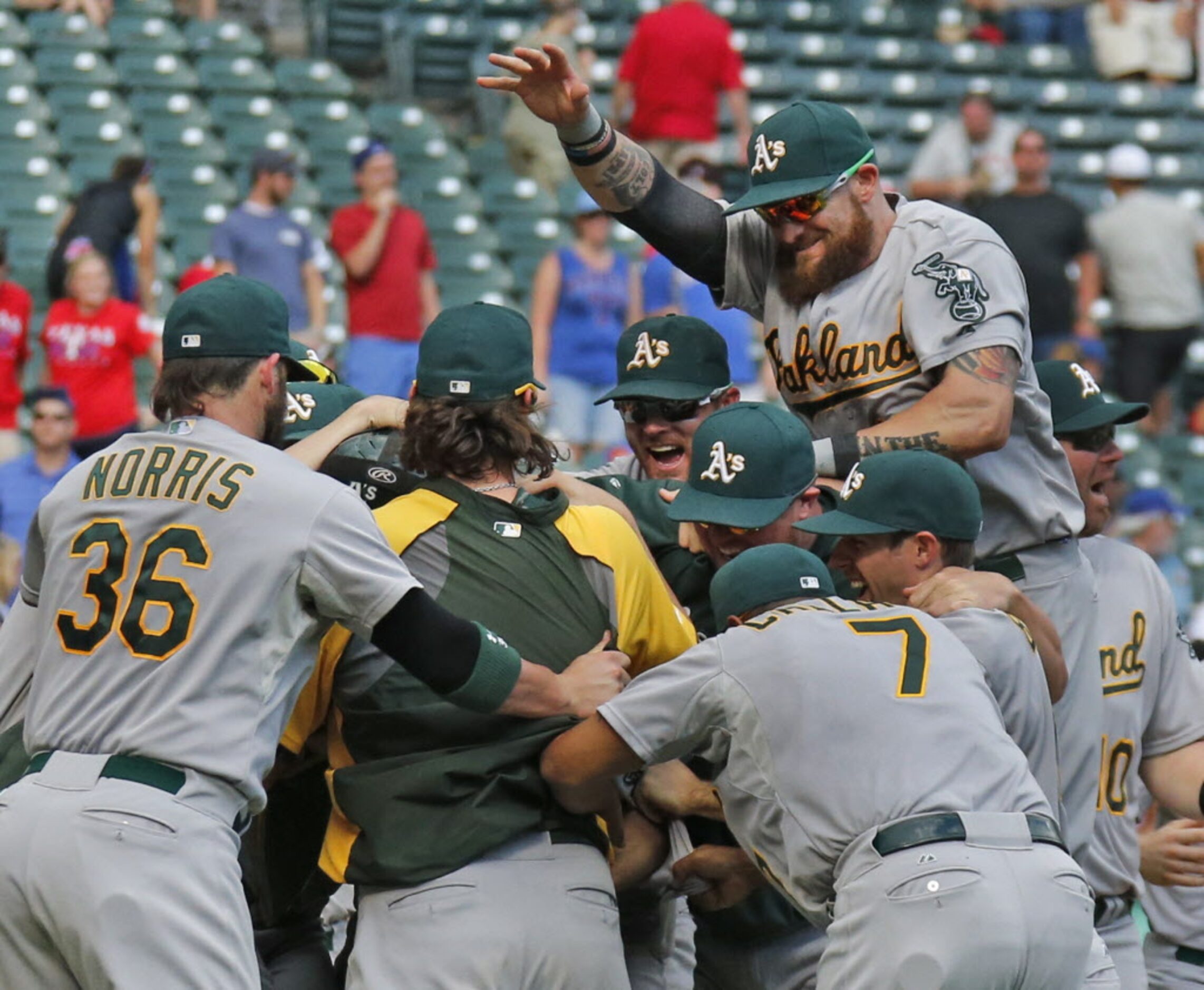 The Oakland A's embrace starting pitcher Sonny Gray after the final out in their wild...