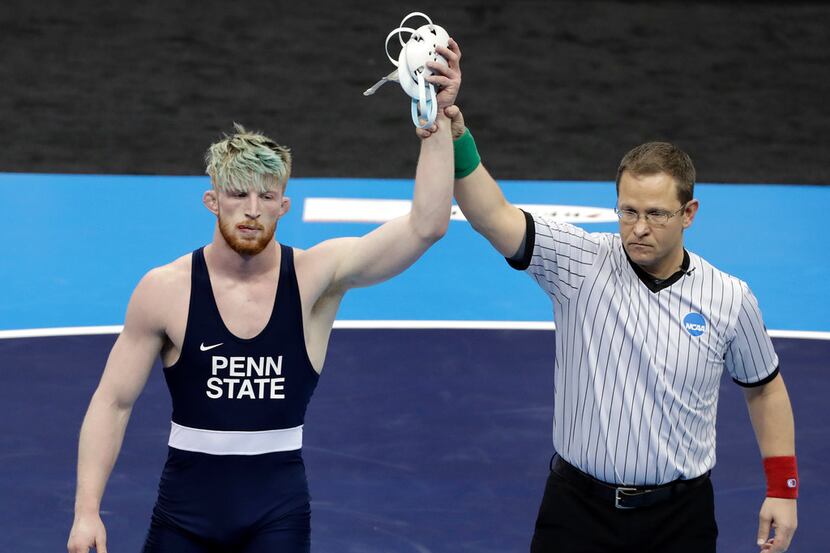 Penn State's Bo Nickal, left, wins his 197-pound match against Ohio State's Kollin Moore in...
