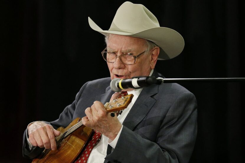 Warren Buffett, CEO of Berkshire Hathaway, plays the ukulele after a question and answer...