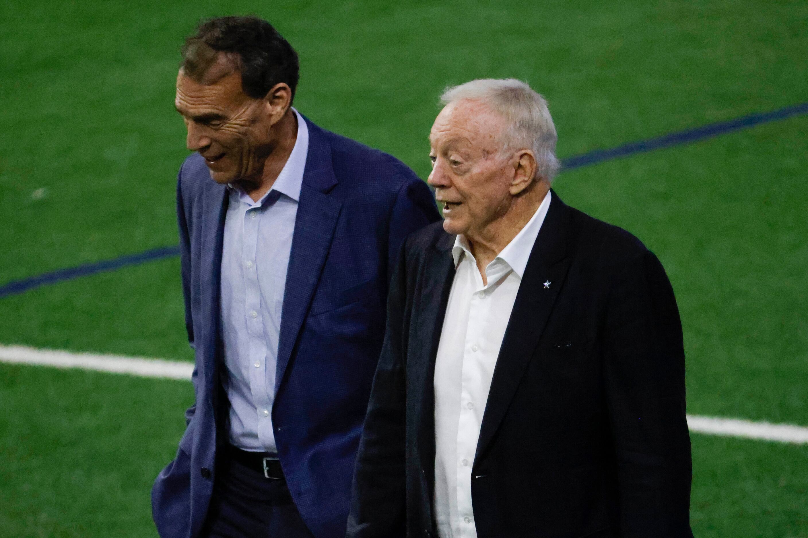 Dallas Cowboys owner Jerry Jones (right) and a business associate walks into the field...