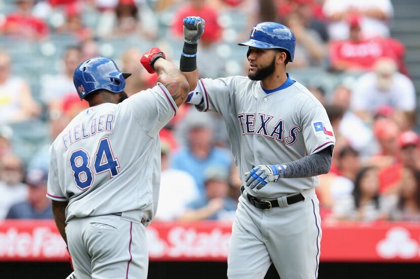ANAHEIM, CALIFORNIA - APRIL 10:  Nomar Mazara #30 of the Texas Rangers is greeted by on deck...