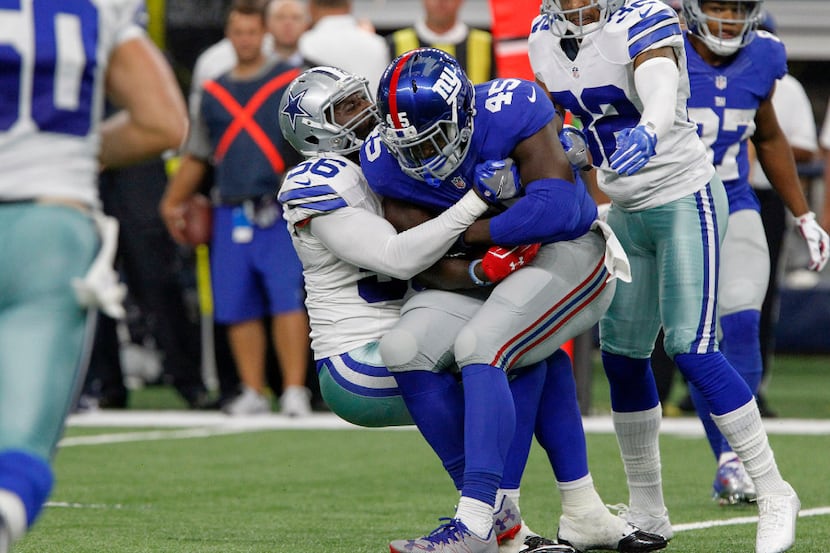 New York Giants tight end Will Tye (45) is wrapped up by Dallas Cowboys linebacker Justin...
