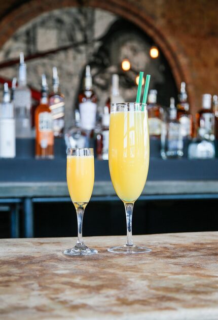 That's the "Giant Flute of Mimosa," on the right. It holds a whole bottle of Champagne....