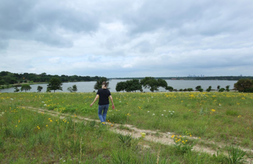 A hiker walks the trail through the blackland prairie at Winfrey Point overlooking White...