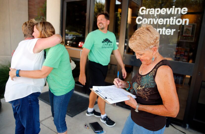 Homeowner Georjean Sherriff (right) signs a letter of petition before the proposed Heritage...