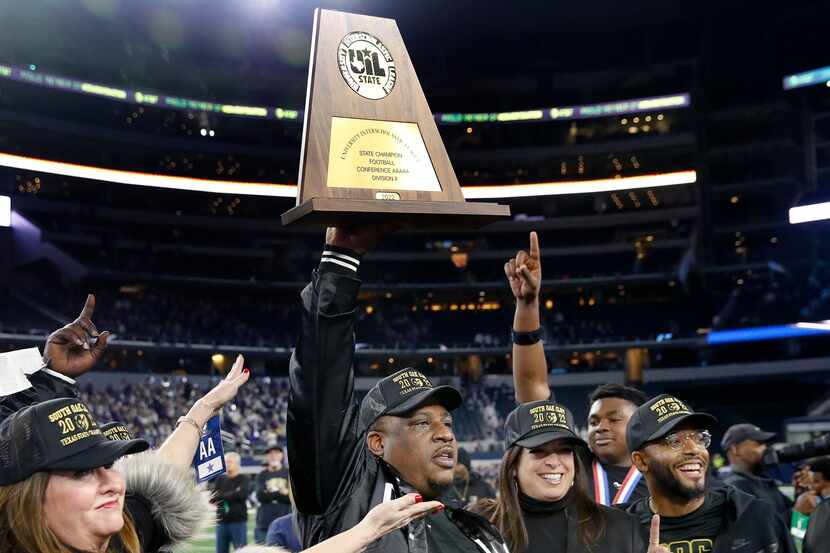South Oak Cliff head coach Clifton Todd hoists the Class 5A Division II state football...