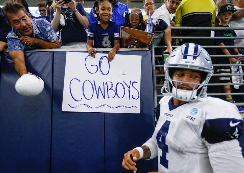 Dallas Cowboys quarterback Dak Prescott (4) signs autographs following Dallas Cowboys...