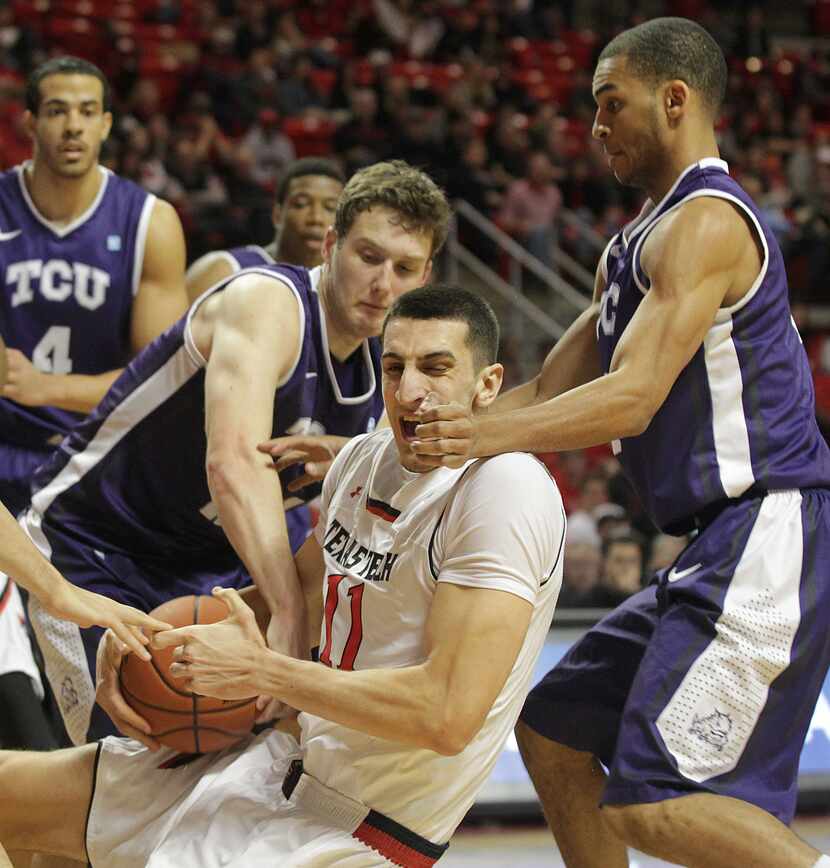 Texas Tech's Dejan Kravic vies for a rebound against TCU's Hudson Price, left, and Clyde...