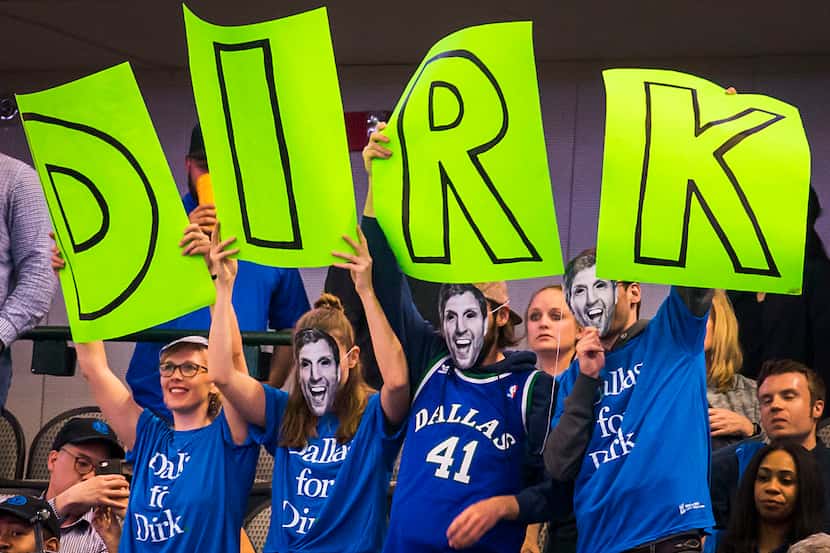 Fans cheer for Dallas Mavericks center Dirk Nowitzki.
