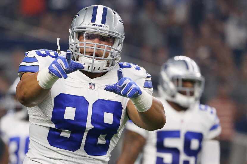 Dallas Cowboys defensive tackle Tyrone Crawford (98) reacts after a play during a preseason...