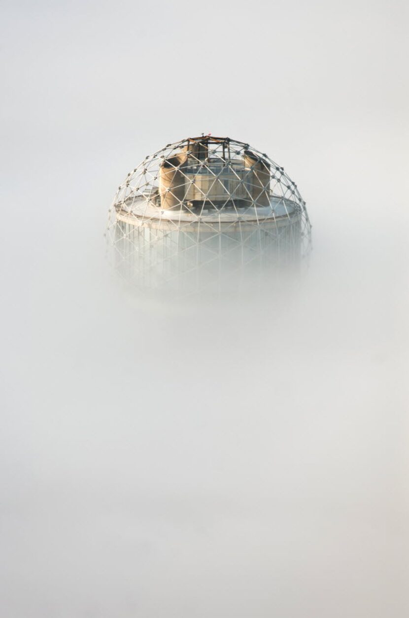 Reunion Tower peeks above the fog as seen from the Bank of America building on Dec. 9, 2014...