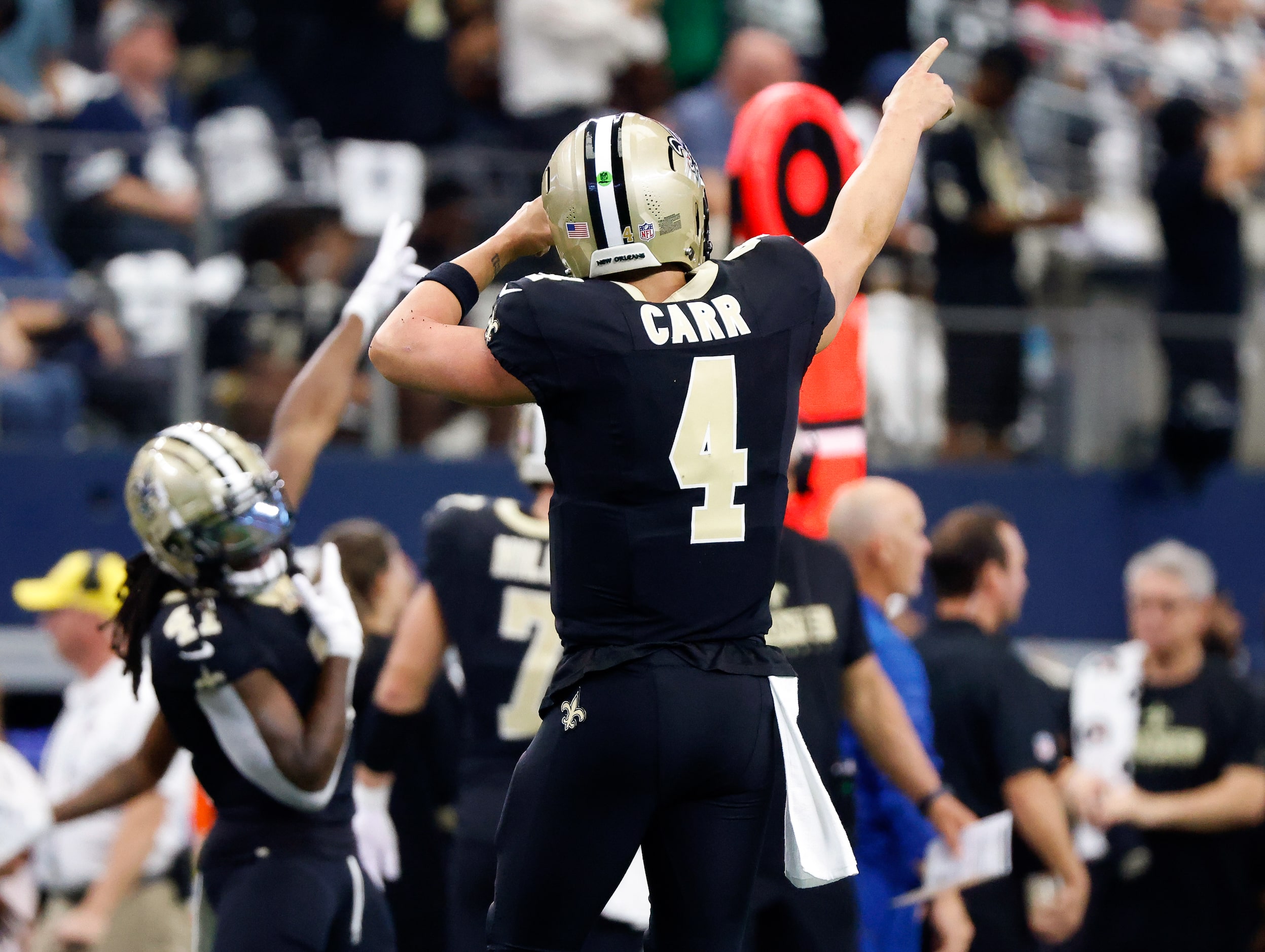 New Orleans Saints quarterback Derek Carr (4) reacts after throwing a deep touchdown pass...