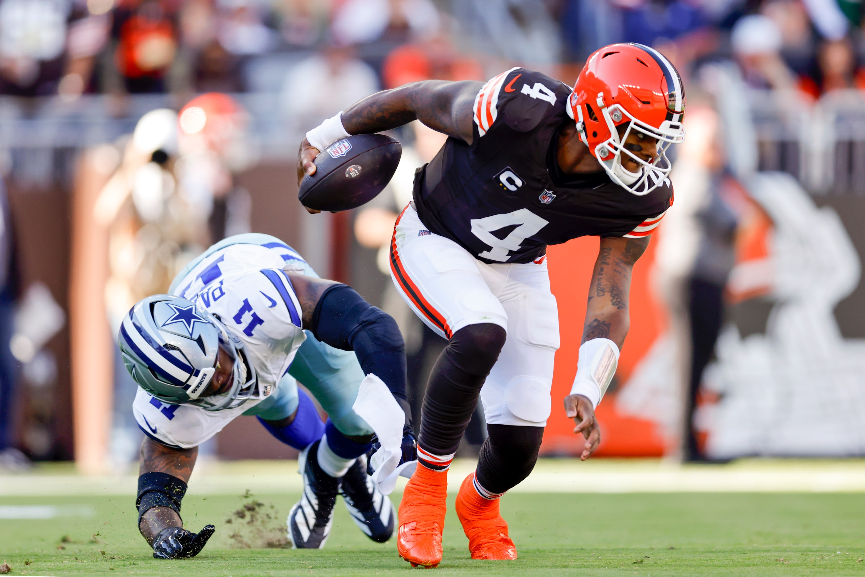 Cleveland Browns quarterback Deshaun Watson (4) slips away from Dallas Cowboys linebacker...