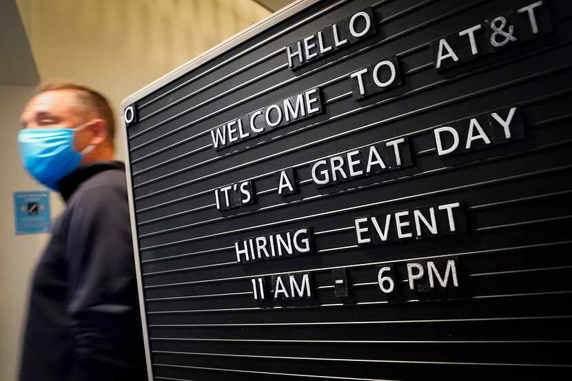 A sign welcomed job candidates to an AT&T hiring event on April 28 in Richardson. The...