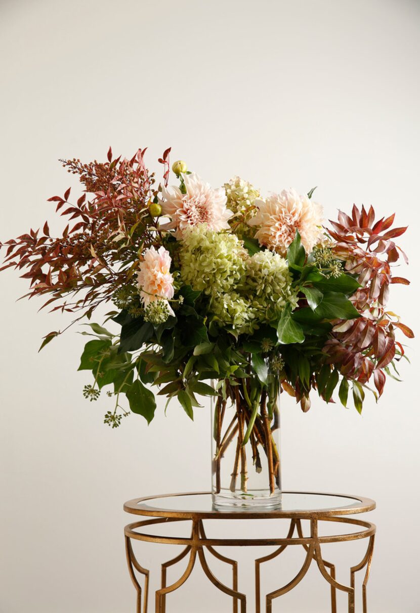 Floral arrangement including pistachio leaves, nandina leaves, bush ivy, Cafe au lait Pee...