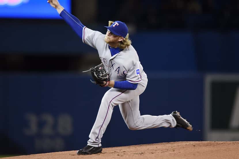 Texas Rangers starting pitcher A.J. Griffin delivers a pitch to the Toronto Blue Jays during...