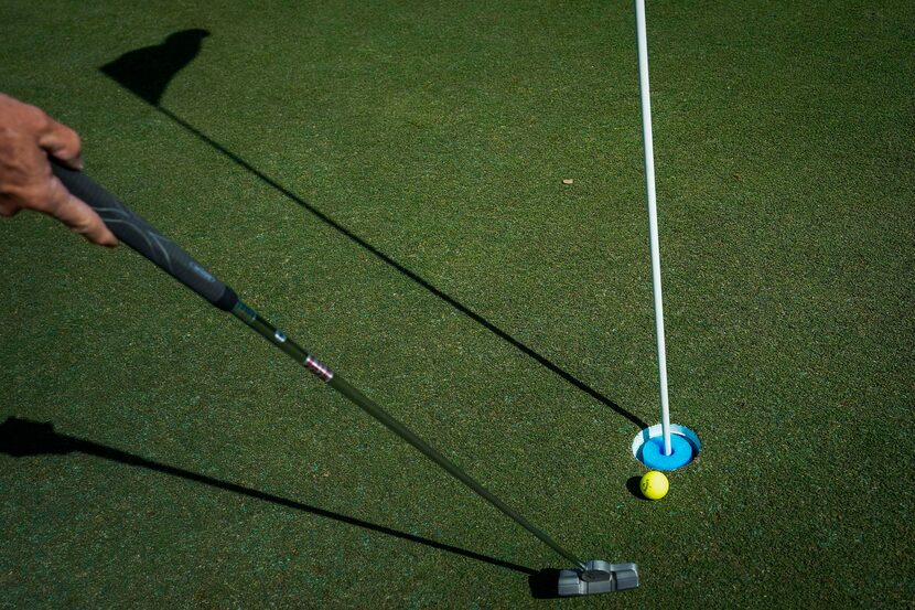 A golfer taps in a put on the first green at Golf Club of Dallas on Wednesday, April 1,...