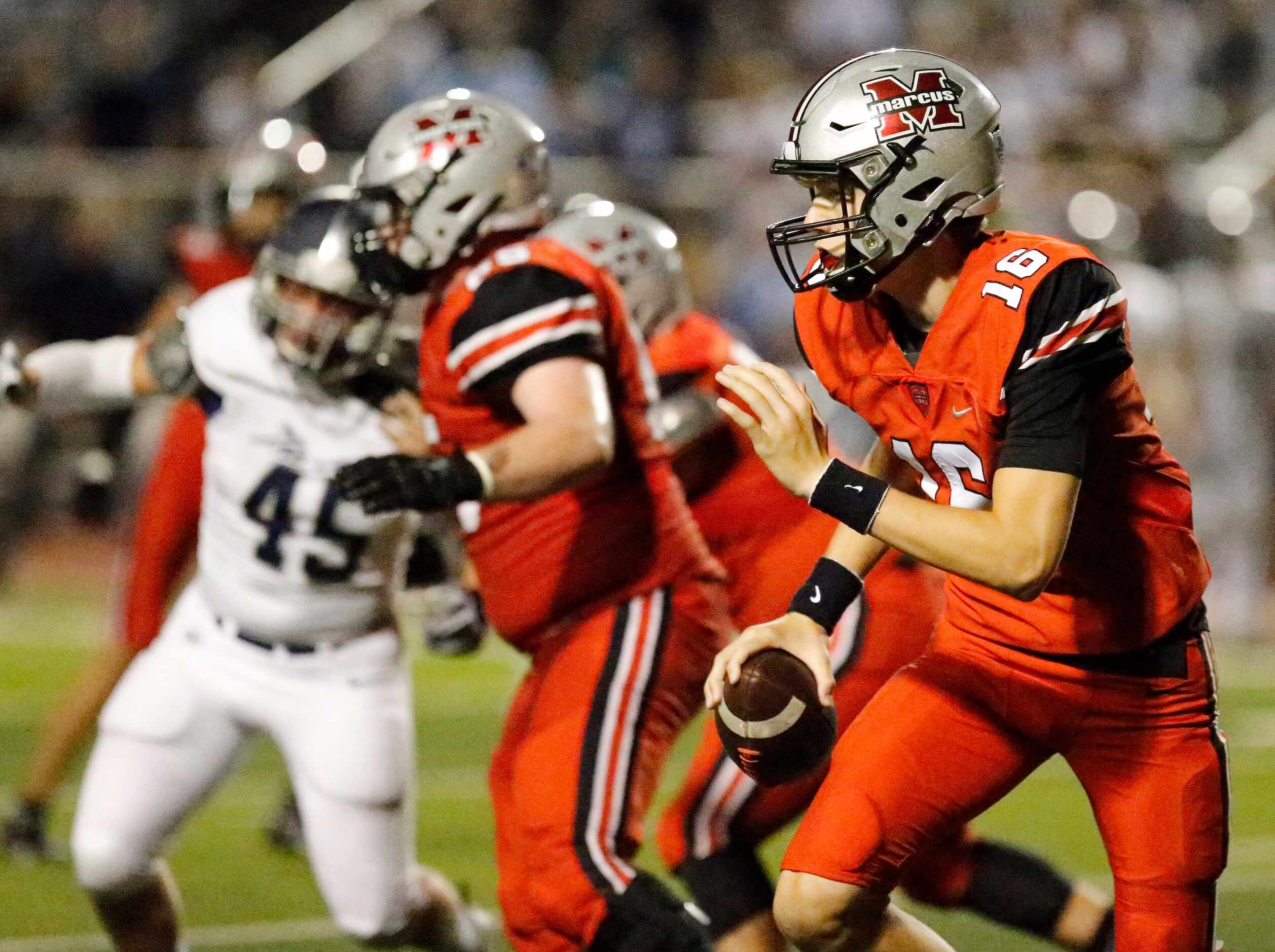 Flower Mound Marcus High School quarterback Jaxxon Warren (16) rolls out on the team’s final...