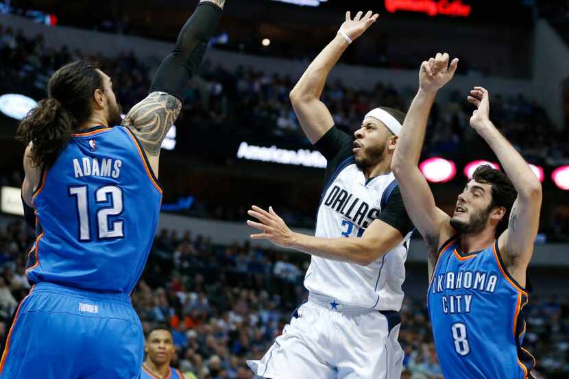 Dallas Mavericks guard Seth Curry (30) shoots in between Oklahoma City Thunder center Steven...