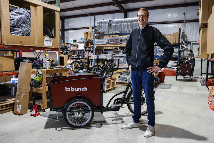 Aaron Powell poses next to one of his bikes at Bunch Bikes in Denton on Wednesday, March 24,...