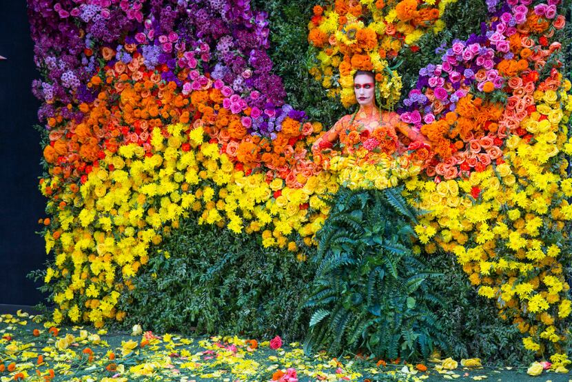 A model poses in the floral wall at the Eye Ball party. The memorable event design was...