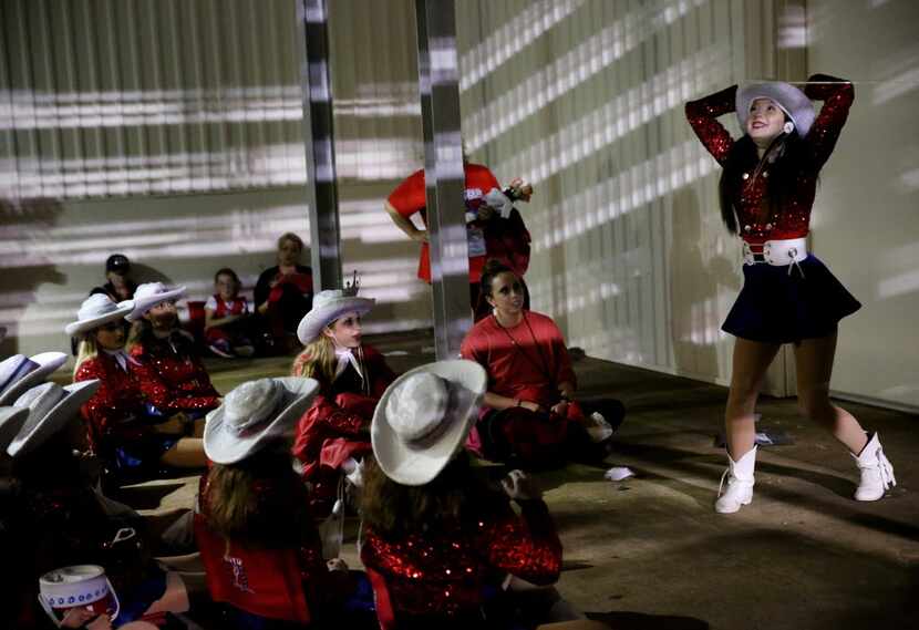 McKinney Boyd Bailadoras member Hannah Atkins (right) takes her turn in charades while...