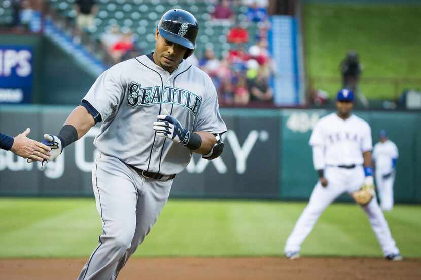 Seattle Mariners designated hitter Nelson Cruz rounds the bases after hitting a home run off...