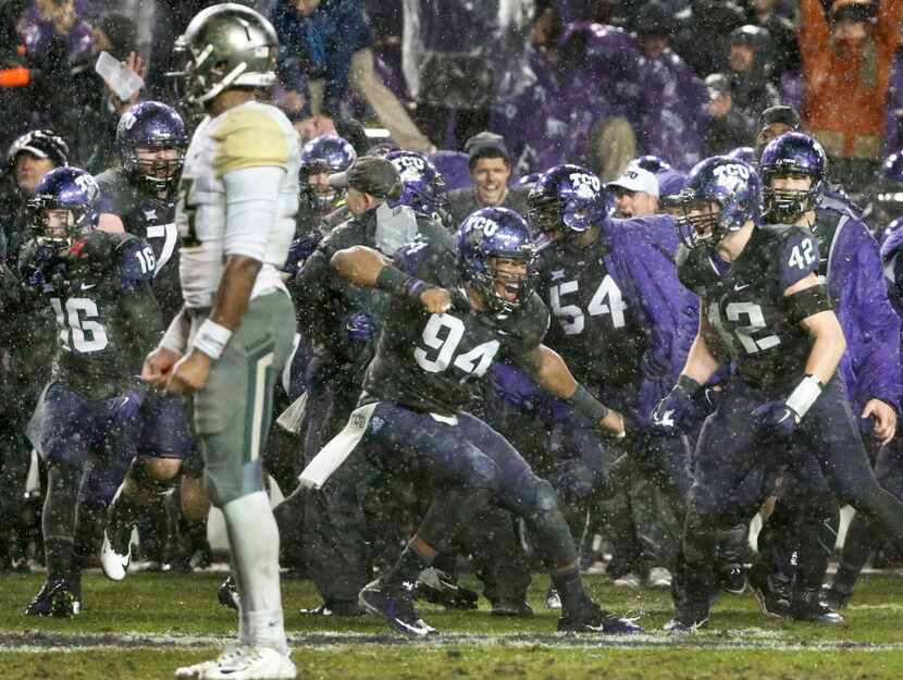 TCU Horned Frogs defensive end Josh Carraway (94) celebrates with teammates after the...