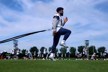 Dallas Cowboys running back Ezekiel Elliott  works out on an exercise band during the team’s...