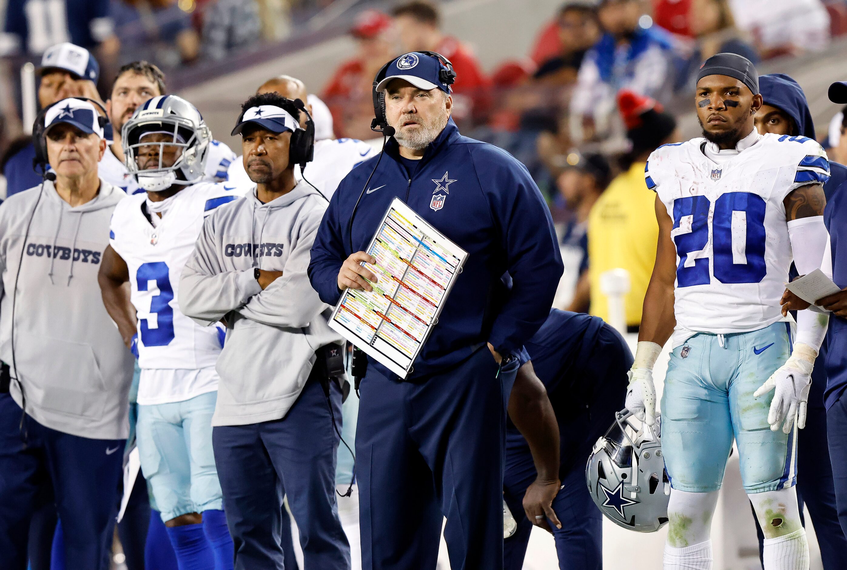 Dallas Cowboys head coach Mike McCarthy and  running back Tony Pollard (20) watch from the...