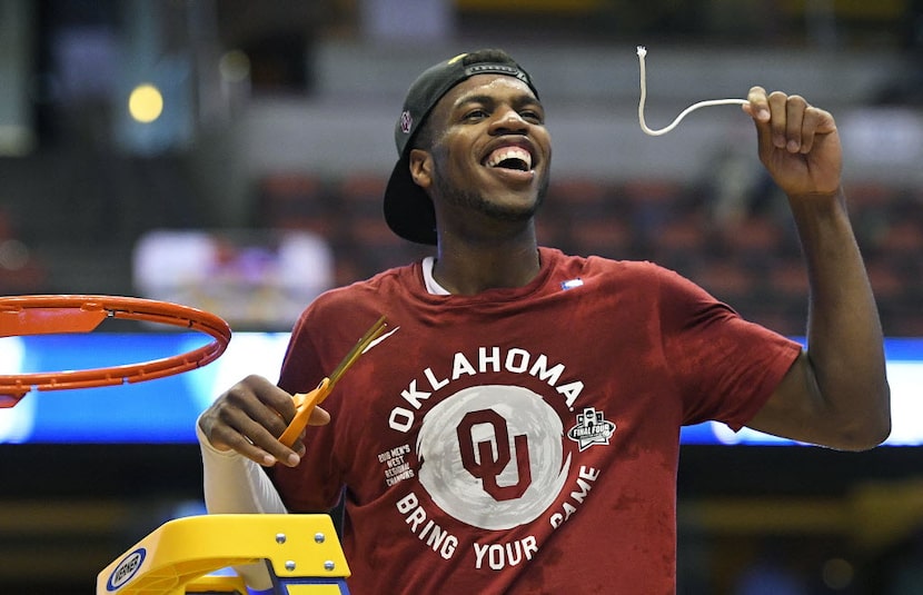 Oklahoma guard Buddy Hield cuts down the net after their win against Oregon during an NCAA...