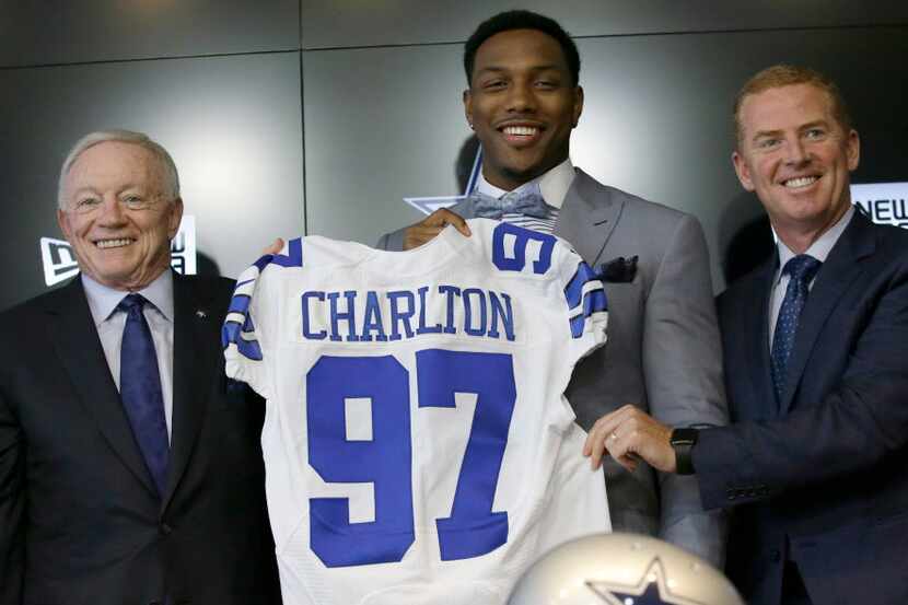 The Dallas Cowboys No. 1 draft pick defensive end Taco Charlton, center, poses for a photos...