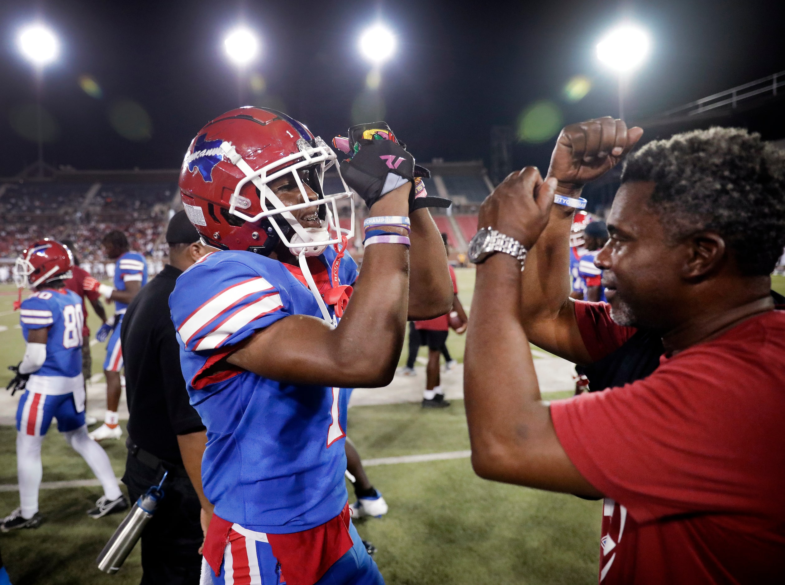 Duncanville wide receiver Dakorien Moore (1) is congratulated on his long first quarter...