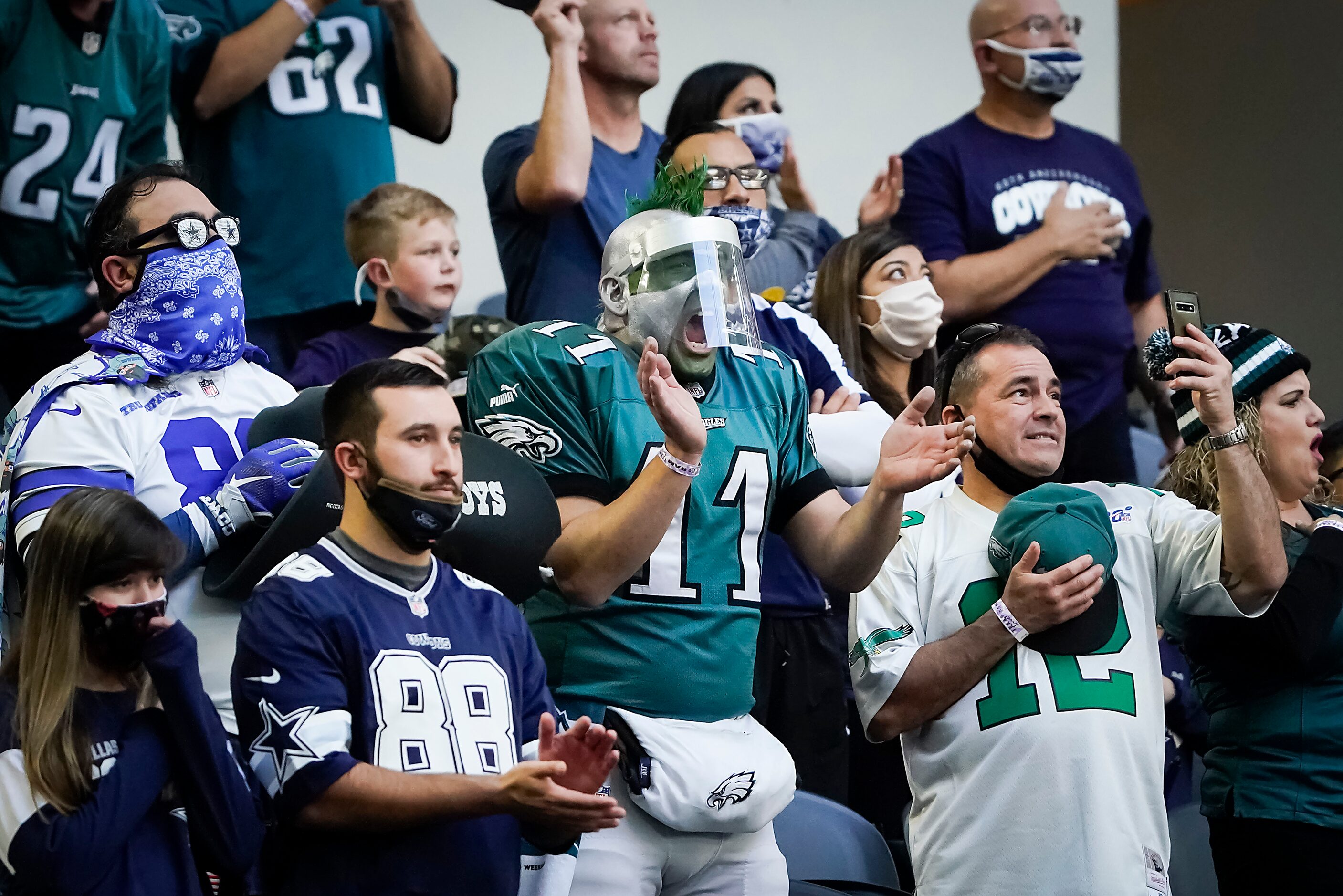 Fans cheer as the teams take the field for an NFL football game between the Dallas Cowboys...