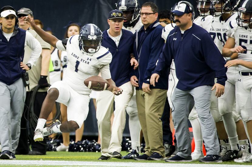 Frisco Lone Star running back Darrin Smith (1) is knocked out of bounds by the Cedar Park...