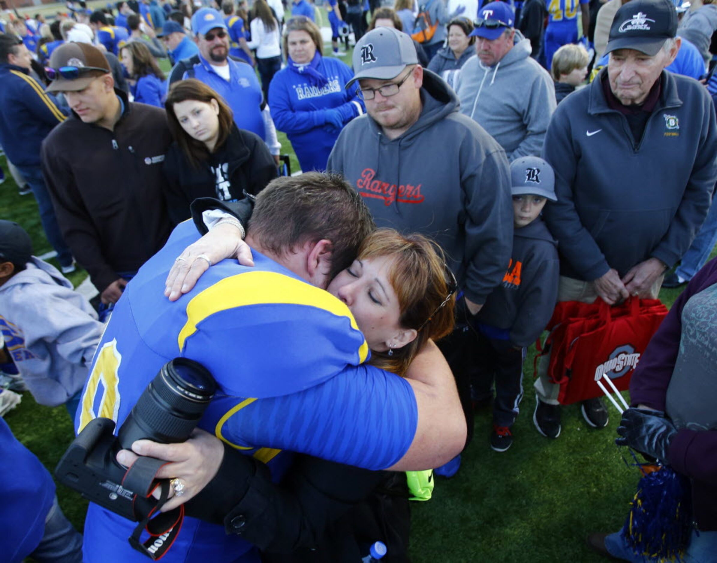 TXHSFB Sunnyvale's Wade Cookston (79) embraces Eva Spera, mother of quarterback Patrick...