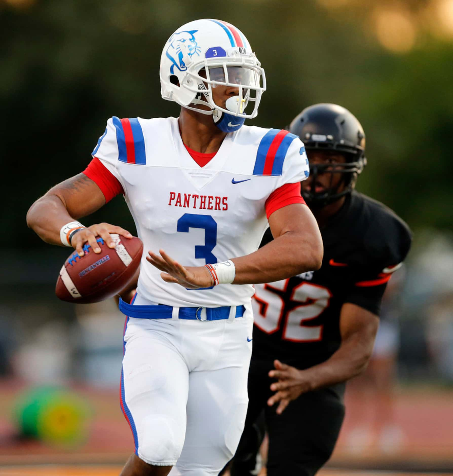 Duncanville quarterback Ja'Quinden Jackson (3) rolls out and passes against Lancaster during...