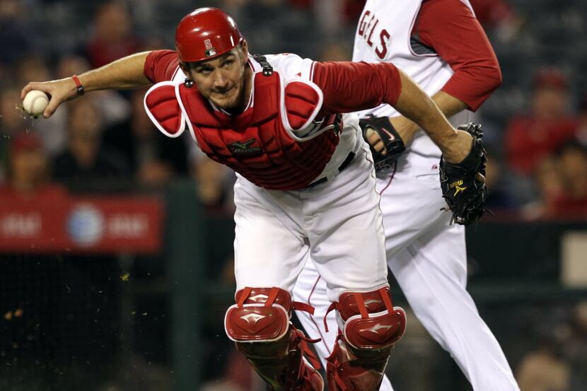 Angels' C Jeff Mathis fields Julio Borbon's tapper and throws him out in the tenth during...