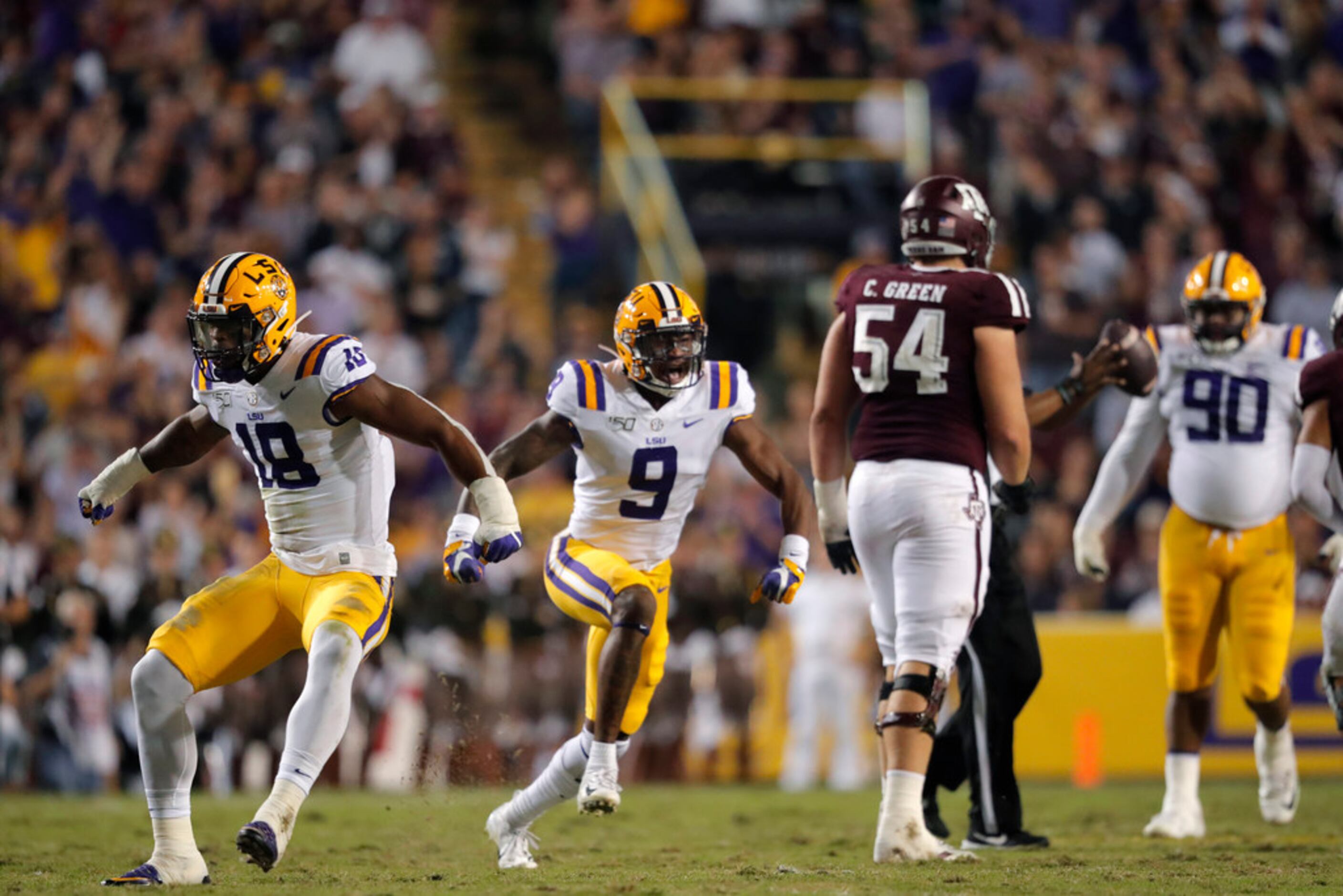 LSU safety Marcel Brooks (9) and linebacker K'Lavon Chaisson (18) celebrate a sack in the...